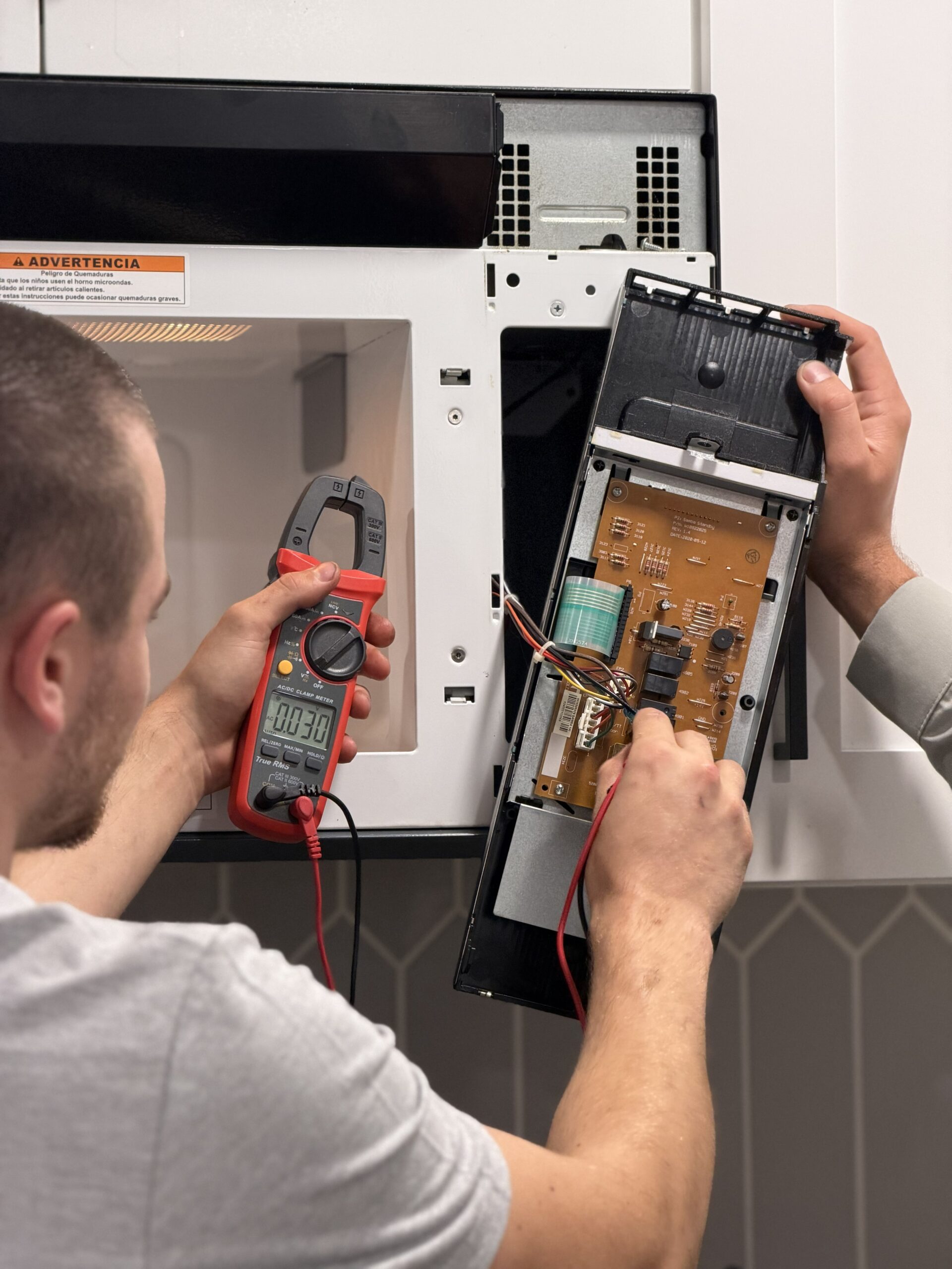 technician working on home appliance repair in San Diego County